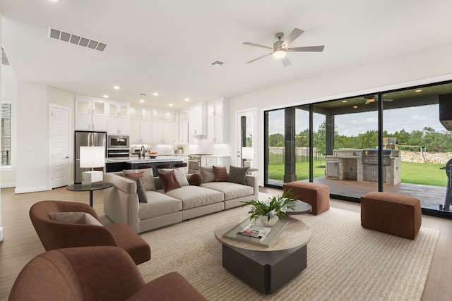 504 Tomichi Trl, Austin, TX 78738 - living room featuring light wood-type flooring, ceiling fan, recessed lighting, and baseboards