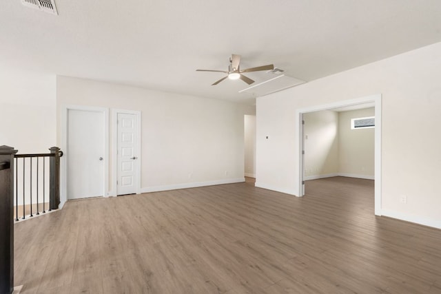 504 Tomichi Trl, Austin, TX 78738 - unfurnished room featuring a ceiling fan, wood finished floors, baseboards, and attic access