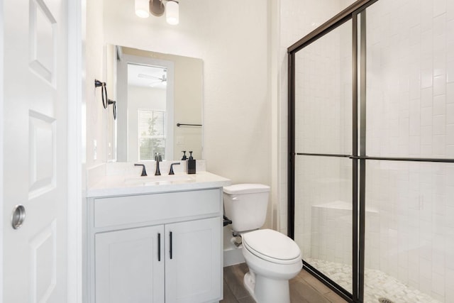 504 Tomichi Trl, Austin, TX 78738 - full bathroom featuring a stall shower, toilet, vanity, and a ceiling fan