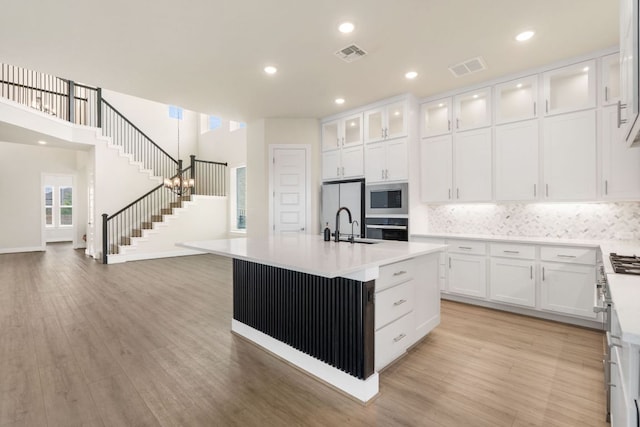 504 Tomichi Trl, Austin, TX 78738 - kitchen featuring stainless steel appliances, white cabinets, light countertops, backsplash, and recessed lighting