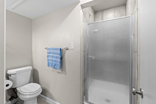 806 W 24th St Unit 302, Austin, TX 78705 - bathroom featuring toilet, a shower stall, and baseboards