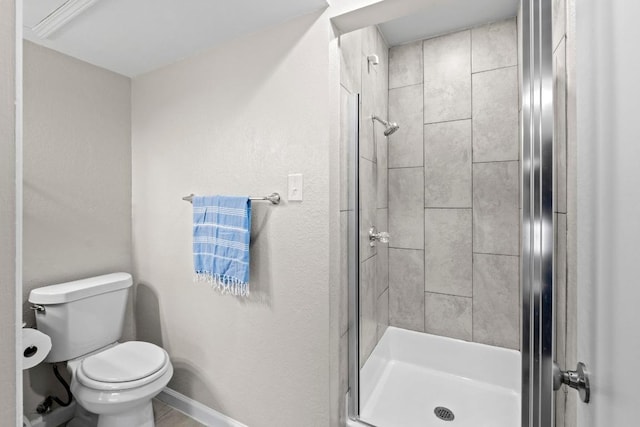 806 W 24th St Unit 302, Austin, TX 78705 - bathroom featuring a shower stall, toilet, and baseboards
