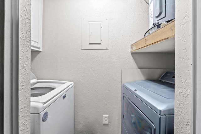 806 W 24th St Unit 302, Austin, TX 78705 - laundry area featuring electric panel, cabinet space, and washing machine and dryer