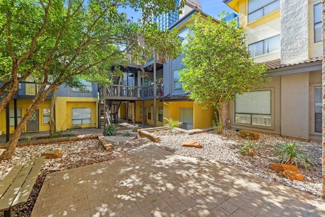 806 W 24th St Unit 302, Austin, TX 78705 - back of property featuring stairway, stucco siding, and a patio
