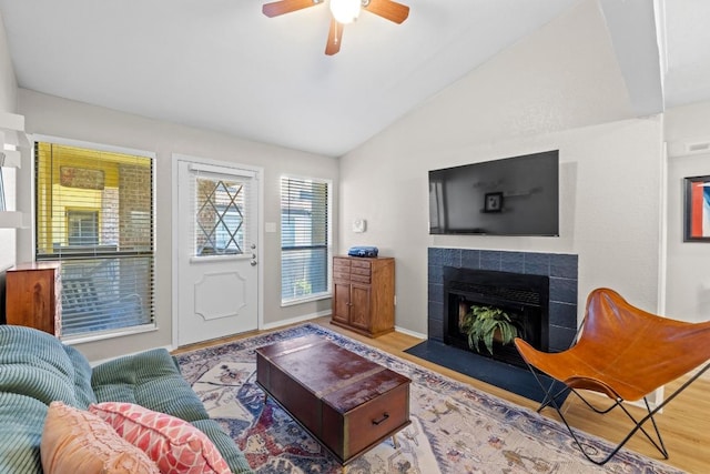 806 W 24th St Unit 302, Austin, TX 78705 - living room featuring lofted ceiling, a tiled fireplace, wood finished floors, and a ceiling fan