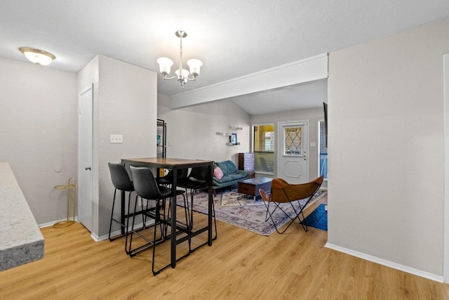 806 W 24th St Unit 302, Austin, TX 78705 - dining space with light wood-type flooring, a chandelier, and baseboards