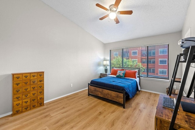 806 W 24th St Unit 302, Austin, TX 78705 - bedroom with a textured ceiling, wood finished floors, lofted ceiling, baseboards, and ceiling fan