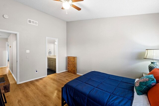806 W 24th St Unit 302, Austin, TX 78705 - bedroom with wood finished floors, baseboards, ceiling fan, and ensuite bathroom