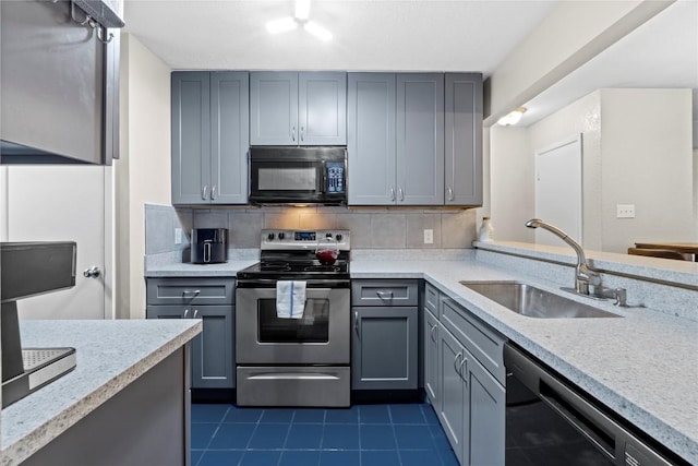 806 W 24th St Unit 302, Austin, TX 78705 - kitchen with black microwave, stainless steel range with electric cooktop, dishwashing machine, a sink, and gray cabinetry