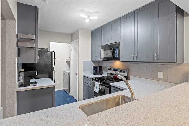 806 W 24th St Unit 302, Austin, TX 78705 - kitchen featuring black microwave, stainless steel range with electric cooktop, washer / clothes dryer, tasteful backsplash, and gray cabinets