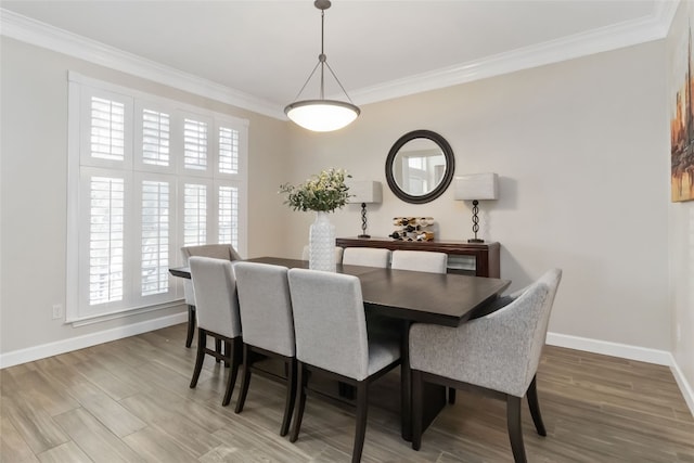 3836 NE Newland Ct, Round Rock, TX 78681 - dining space featuring ornamental molding, baseboards, and wood finished floors