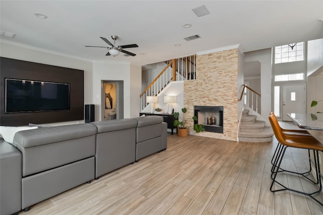 3836 NE Newland Ct, Round Rock, TX 78681 - living area featuring stairway, light wood-style floors, a ceiling fan, and crown molding