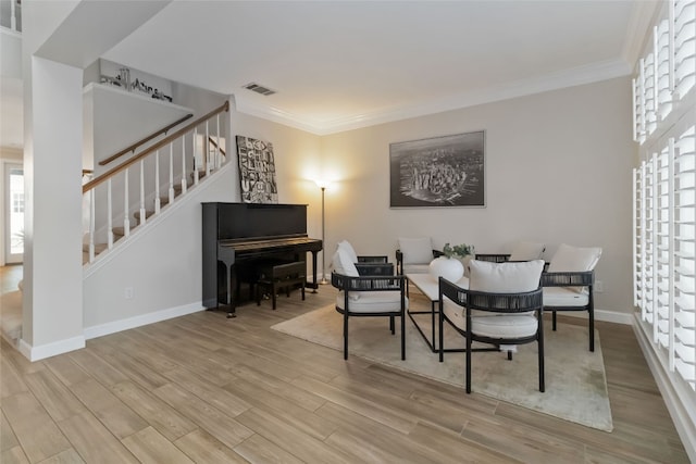 3836 NE Newland Ct, Round Rock, TX 78681 - living area featuring stairs, wood finished floors, and ornamental molding