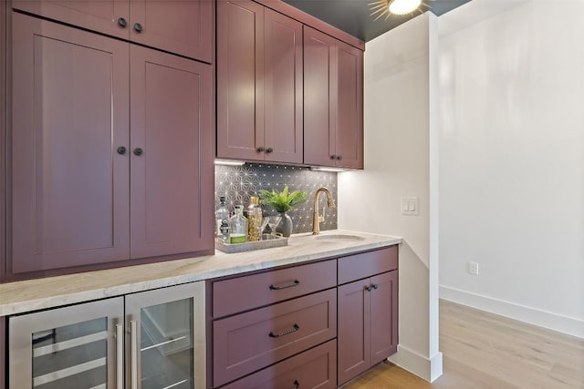 4600 Parkdale Pl Unit 1, Austin, TX 78745 - indoor wet bar featuring beverage cooler, tasteful backsplash, and light wood-type flooring