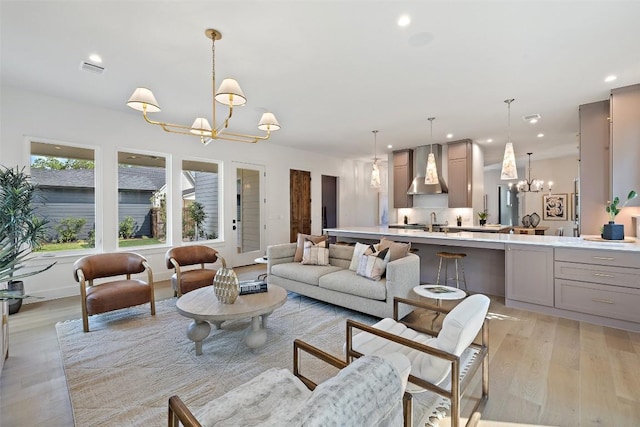 4600 Parkdale Pl Unit 1, Austin, TX 78745 - living room with a chandelier, light wood-style flooring, and recessed lighting
