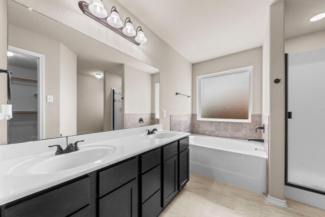 4201 Colonel Dr, Killeen, TX 76549 - bathroom featuring a garden tub, double vanity, and tile patterned flooring