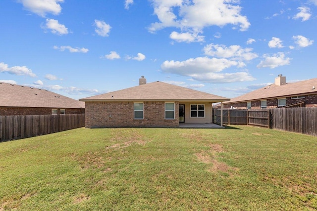 4201 Colonel Dr, Killeen, TX 76549 - rear view of house with a fenced backyard, a patio area, brick siding, and a chimney