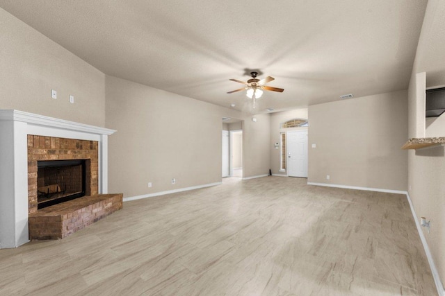 4201 Colonel Dr, Killeen, TX 76549 - unfurnished living room featuring a brick fireplace, ceiling fan, and light wood-style flooring