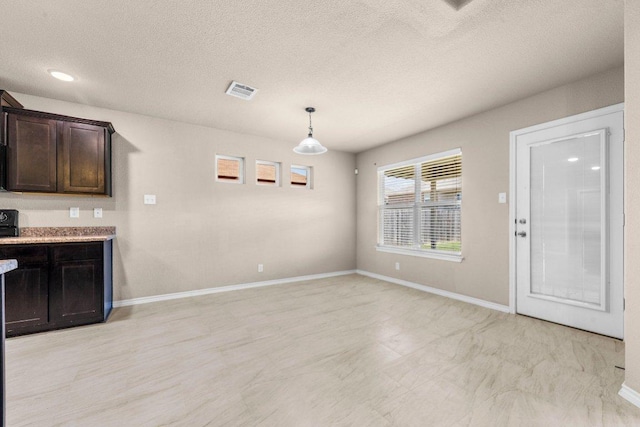 4201 Colonel Dr, Killeen, TX 76549 - unfurnished dining area featuring a textured ceiling