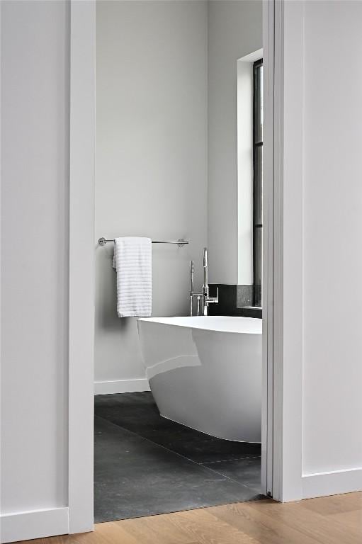 2635 Barton Hills Dr, Austin, TX 78704 - full bath featuring a freestanding tub and wood finished floors