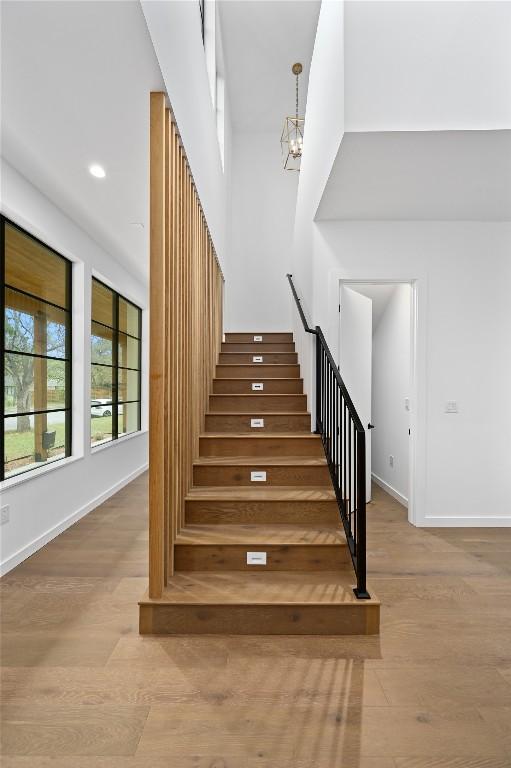 2635 Barton Hills Dr, Austin, TX 78704 - stairway with wood finished floors, a chandelier, and recessed lighting
