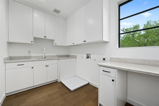 2635 Barton Hills Dr, Austin, TX 78704 - laundry area featuring hookup for an electric dryer, dark wood-style floors, hookup for a washing machine, and cabinet space