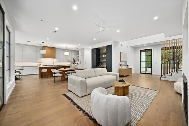 2635 Barton Hills Dr, Austin, TX 78704 - living area featuring recessed lighting, a ceiling fan, light wood-style flooring, and stairs