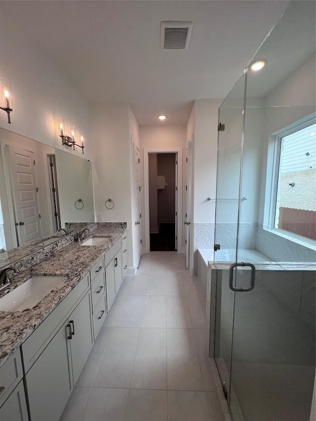 1340 Robin Trl, Round Rock, TX 78681 - full bath featuring double vanity, a shower stall, tile patterned flooring, and baseboards