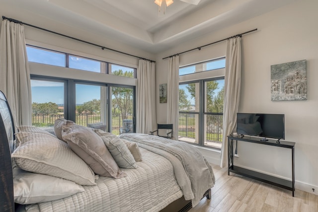 3305 Close Call, Horseshoe Bay, TX 78657 - bedroom with light wood-style floors, a raised ceiling, access to outside, and baseboards