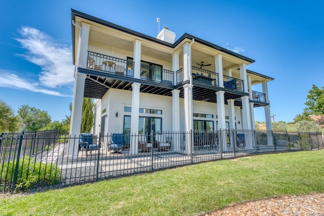 3305 Close Call, Horseshoe Bay, TX 78657 - back of property with a balcony, a chimney, a patio area, stucco siding, and a ceiling fan