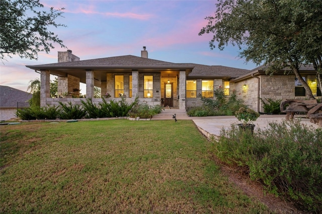 201 Greenridge Ln, Dripping Springs, TX 78620 - view of front of property with a chimney, stone siding, a front yard, and driveway