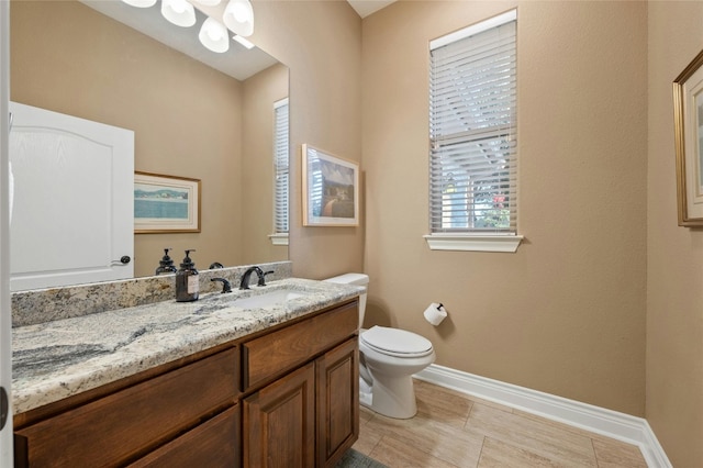 201 Greenridge Ln, Dripping Springs, TX 78620 - bathroom featuring baseboards, vanity, and toilet