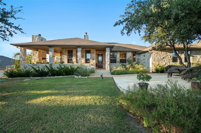 201 Greenridge Ln, Dripping Springs, TX 78620 - view of front facade featuring stone siding, a chimney, and a front yard