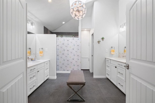 12519 Split Rail Pkwy, Austin, TX 78750 - full bath with a tile shower, two vanities, and lofted ceiling