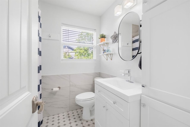 12519 Split Rail Pkwy, Austin, TX 78750 - full bath featuring vanity, tile patterned floors, tile walls, and wainscoting