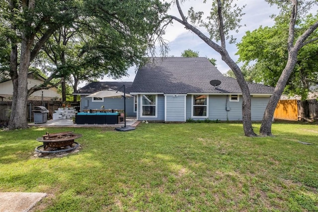 12519 Split Rail Pkwy, Austin, TX 78750 - rear view of house with a fenced backyard, an outdoor living space with a fire pit, roof with shingles, and a patio