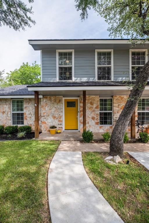 12519 Split Rail Pkwy, Austin, TX 78750 - view of front facade with stone siding and a front lawn