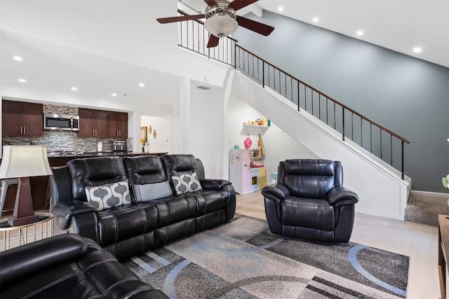 12519 Split Rail Pkwy, Austin, TX 78750 - living area with a ceiling fan, recessed lighting, stairway, and a towering ceiling
