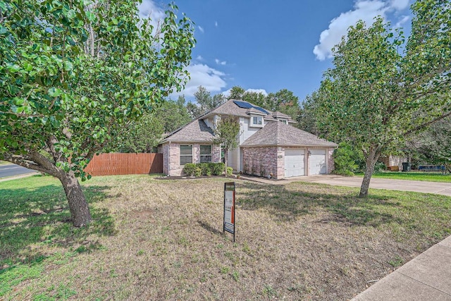 8660 Ephraim Rd, Austin, TX 78717 - view of front of house with concrete driveway, an attached garage, and brick siding