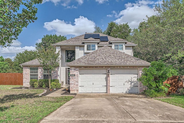 8660 Ephraim Rd, Austin, TX 78717 - traditional-style house featuring a garage, roof mounted solar panels, driveway, and roof with shingles