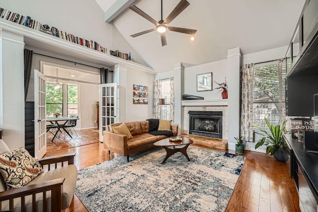 8660 Ephraim Rd, Austin, TX 78717 - living room featuring a ceiling fan, hardwood / wood-style flooring, high vaulted ceiling, a tile fireplace, and plenty of natural light