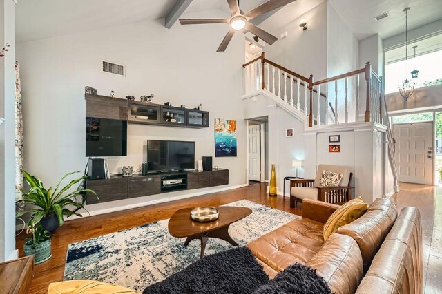 8660 Ephraim Rd, Austin, TX 78717 - living area featuring high vaulted ceiling, wood finished floors, stairway, beam ceiling, and a ceiling fan