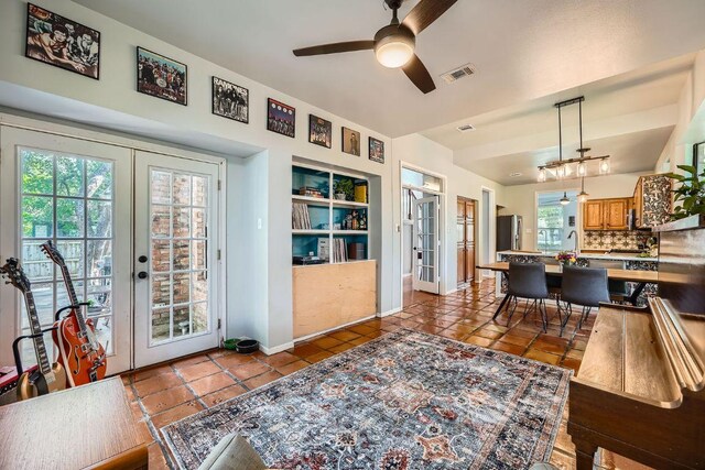 8660 Ephraim Rd, Austin, TX 78717 - dining area featuring french doors, ceiling fan, tile patterned floors, and baseboards