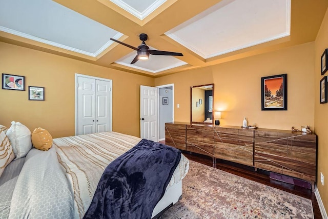8660 Ephraim Rd, Austin, TX 78717 - bedroom with wood finished floors, ornamental molding, a ceiling fan, coffered ceiling, and a closet