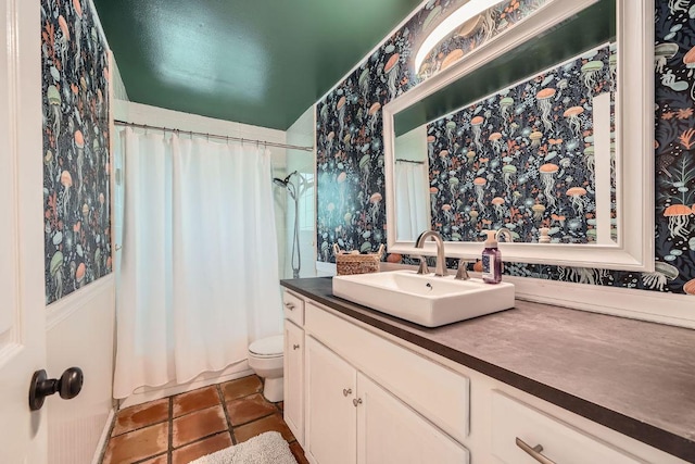 8660 Ephraim Rd, Austin, TX 78717 - full bath with wallpapered walls, vanity, toilet, and tile patterned floors