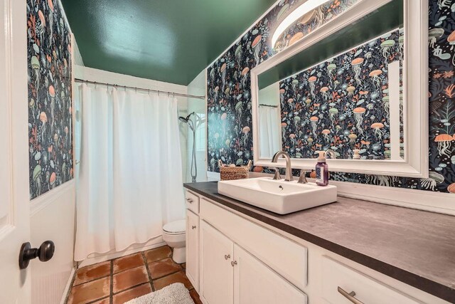 8660 Ephraim Rd, Austin, TX 78717 - bathroom with wallpapered walls, vanity, tile patterned flooring, and toilet