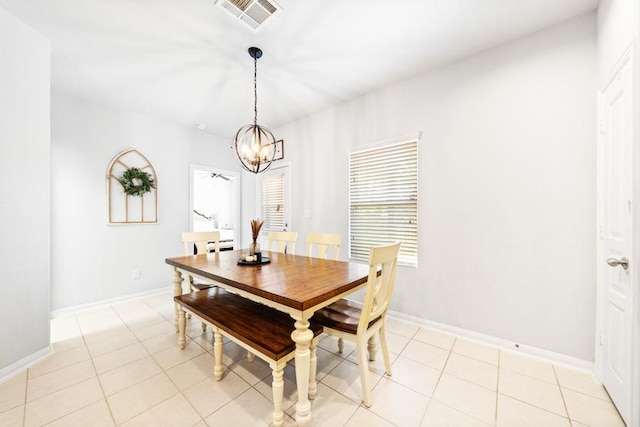 400 Westminster Dr, Kyle, TX 78640 - dining space featuring a chandelier, light tile patterned flooring, and baseboards