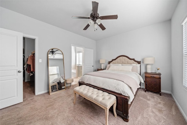 400 Westminster Dr, Kyle, TX 78640 - bedroom featuring a spacious closet, light colored carpet, multiple windows, and ensuite bath