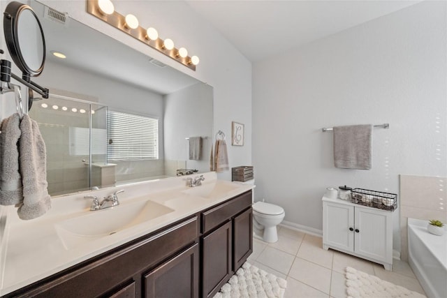 400 Westminster Dr, Kyle, TX 78640 - full bath with a bath, tile patterned floors, double vanity, a stall shower, and toilet