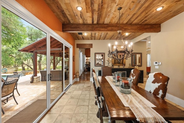 131 Camino Derecho, Wimberley, TX 78676 - dining room featuring recessed lighting, a chandelier, baseboards, wood ceiling with exposed beams, and stone tile flooring